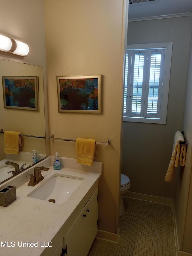 114 S 49th Hwy, Indianola, MS 38751 - bathroom featuring vanity, toilet, tile patterned flooring, and baseboards
