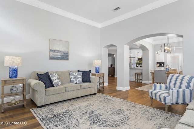 2252 Beach Dr Unit 606, Gulfport, MS 39507 - living room featuring wood finished floors, ornamental molding, and arched walkways