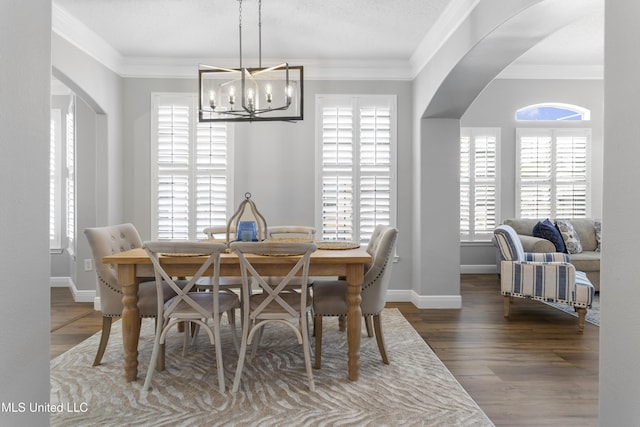 2252 Beach Dr Unit 606, Gulfport, MS 39507 - dining space featuring arched walkways, a chandelier, wood finished floors, and ornamental molding