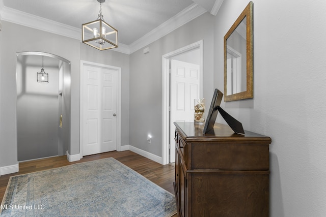 2252 Beach Dr Unit 606, Gulfport, MS 39507 - foyer with arched walkways, a chandelier, dark wood-style floors, and crown molding