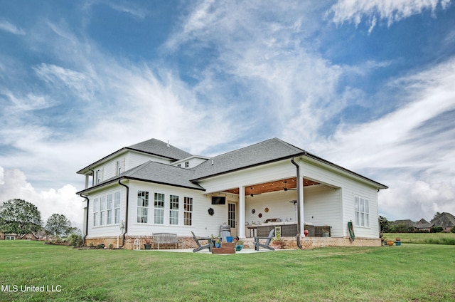 back of house featuring a patio and a yard