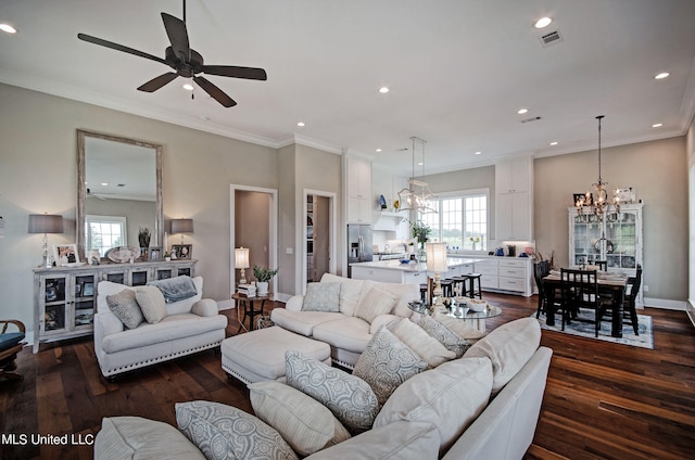 living room featuring ornamental molding, ceiling fan with notable chandelier, and dark hardwood / wood-style flooring