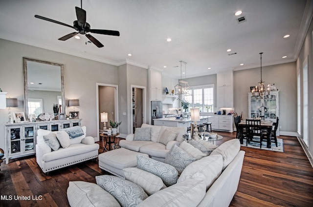 living room featuring crown molding, ceiling fan with notable chandelier, and dark hardwood / wood-style flooring