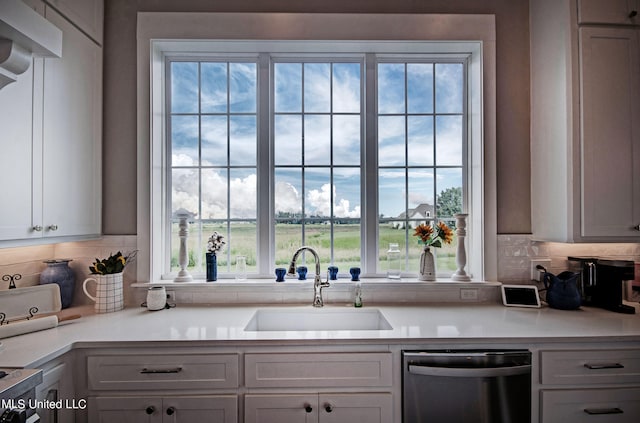 kitchen with decorative backsplash, black stove, sink, stainless steel dishwasher, and white cabinets