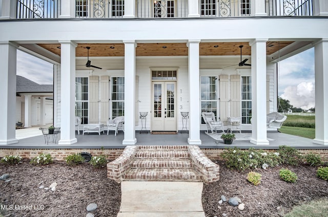 property entrance featuring a patio area, french doors, a balcony, and ceiling fan