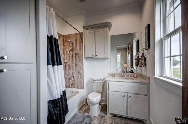 full bathroom with hardwood / wood-style floors, shower / tub combo, toilet, ornamental molding, and vanity