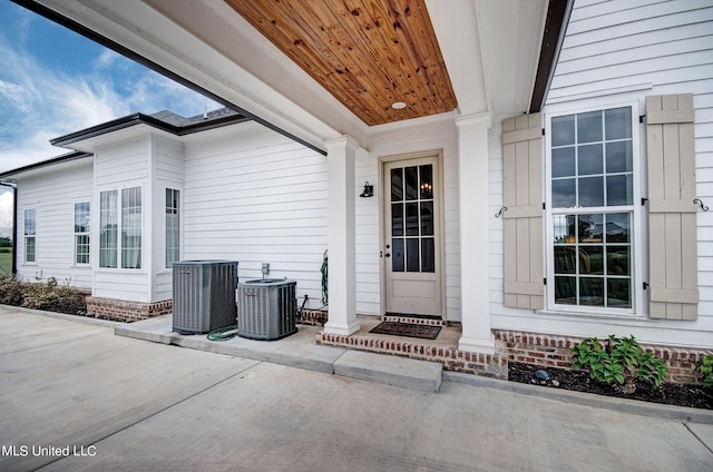 doorway to property featuring a patio area and central AC unit