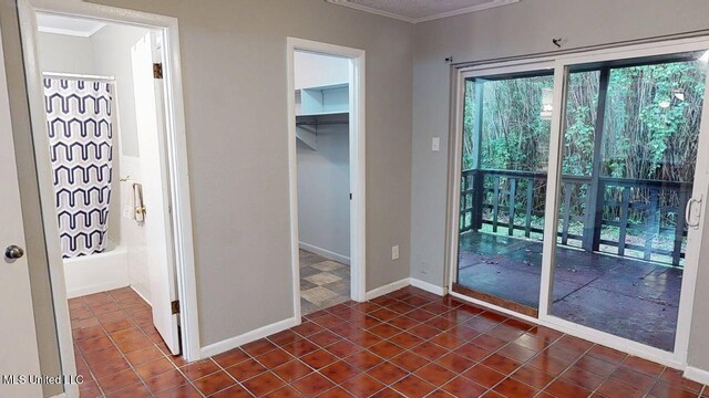 413 Kahler St Unit 27, Gulfport, MS 39507 - entryway with crown molding, dark tile patterned flooring, and baseboards