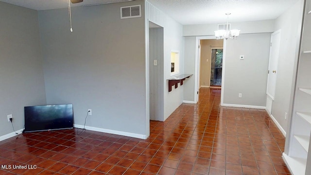 413 Kahler St Unit 27, Gulfport, MS 39507 - spare room featuring a chandelier, tile patterned floors, and baseboards