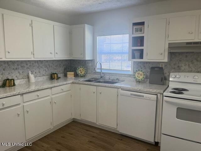 kitchen with a textured ceiling, white cabinetry, sink, and white appliances