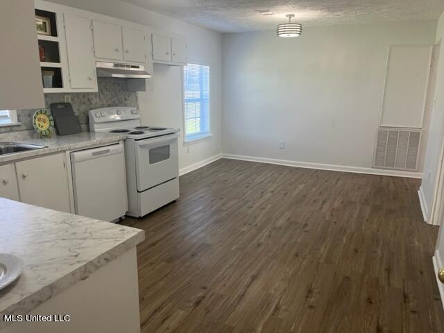 kitchen with white cabinetry, a textured ceiling, ventilation hood, and white appliances