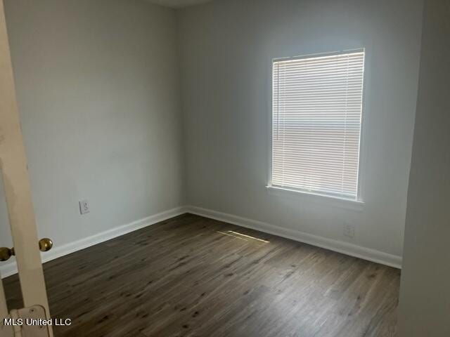 unfurnished room featuring dark hardwood / wood-style floors