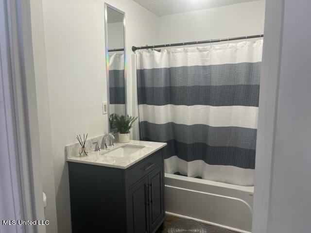 bathroom featuring vanity and shower / bath combo