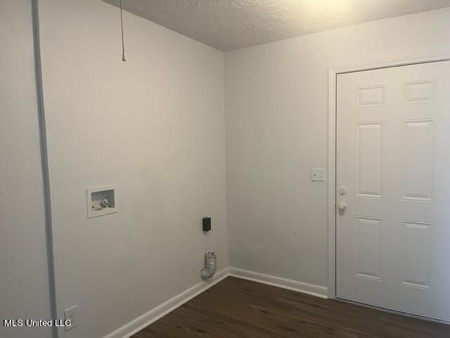 washroom with a textured ceiling, washer hookup, and dark hardwood / wood-style flooring