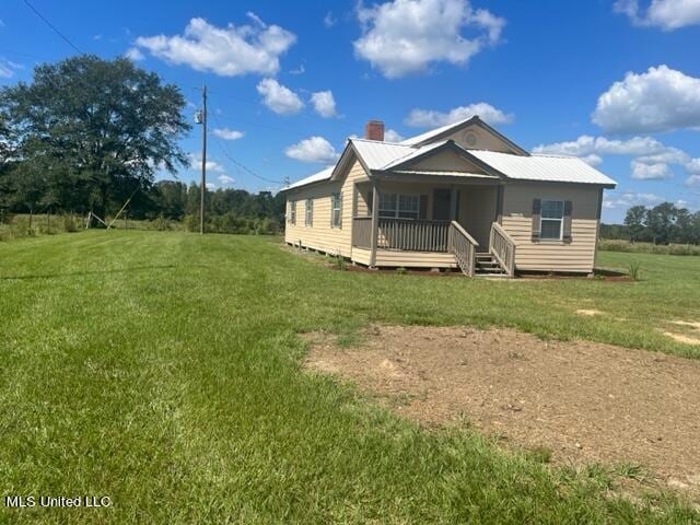 back of property featuring a yard