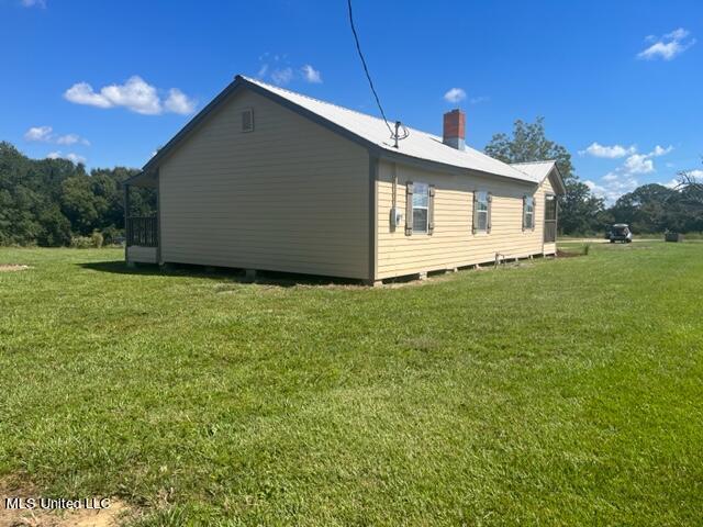 view of home's exterior with a lawn