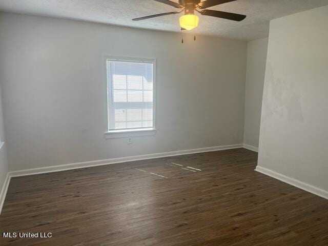 empty room with ceiling fan, a textured ceiling, and dark hardwood / wood-style flooring