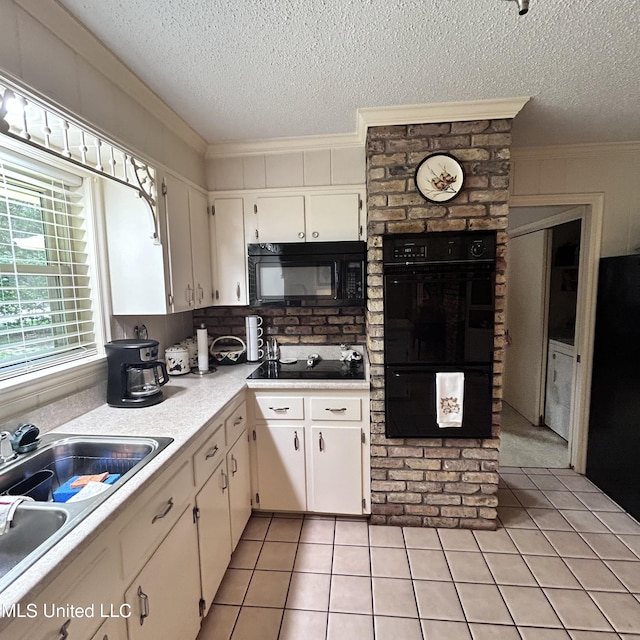 kitchen with ornamental molding, white cabinetry, black appliances, and light tile patterned floors