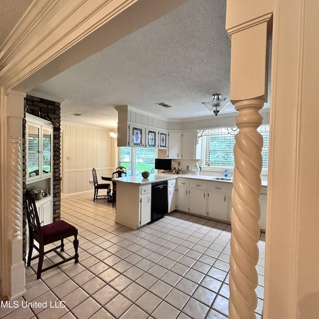 kitchen with kitchen peninsula, white cabinetry, black dishwasher, and a textured ceiling