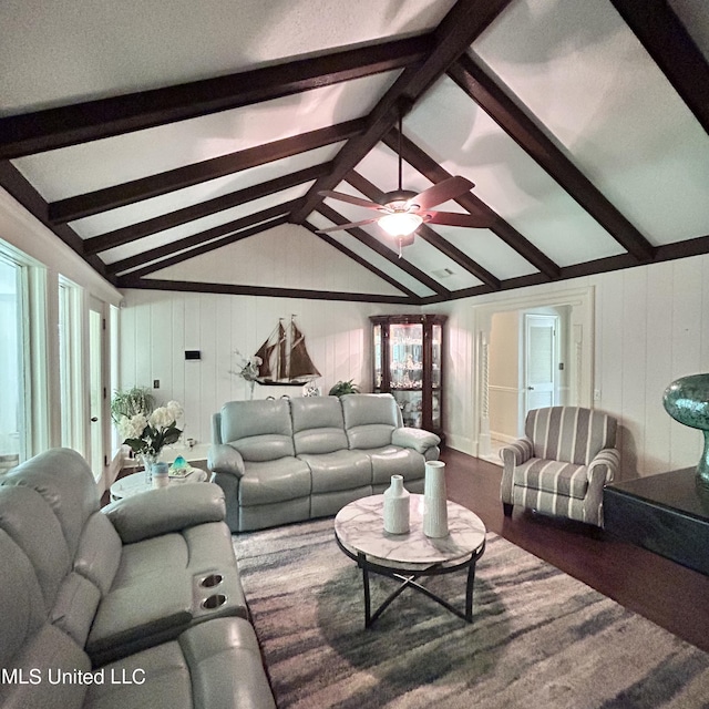 living room featuring ceiling fan, wood walls, vaulted ceiling with beams, and dark hardwood / wood-style floors