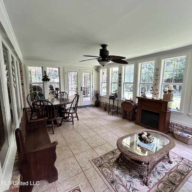 sunroom / solarium featuring a wealth of natural light and ceiling fan