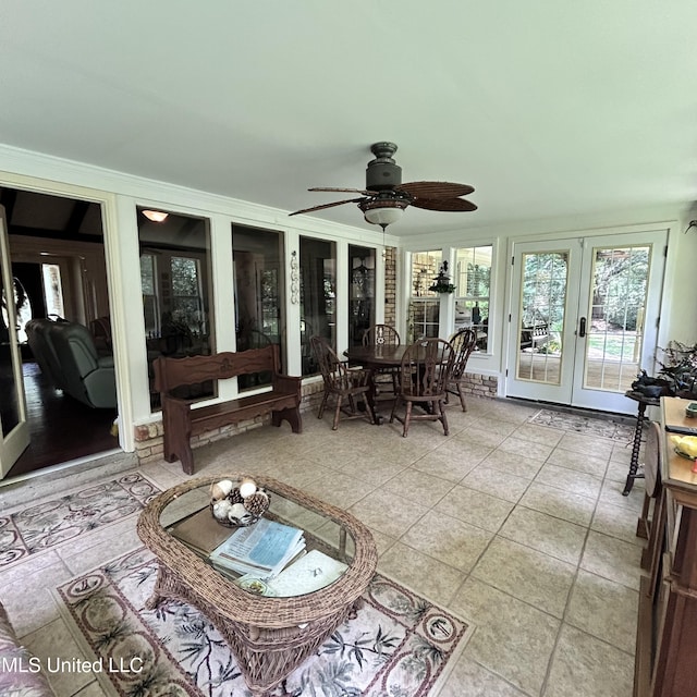 sunroom / solarium featuring french doors and ceiling fan