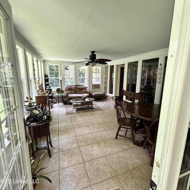 sunroom featuring ceiling fan