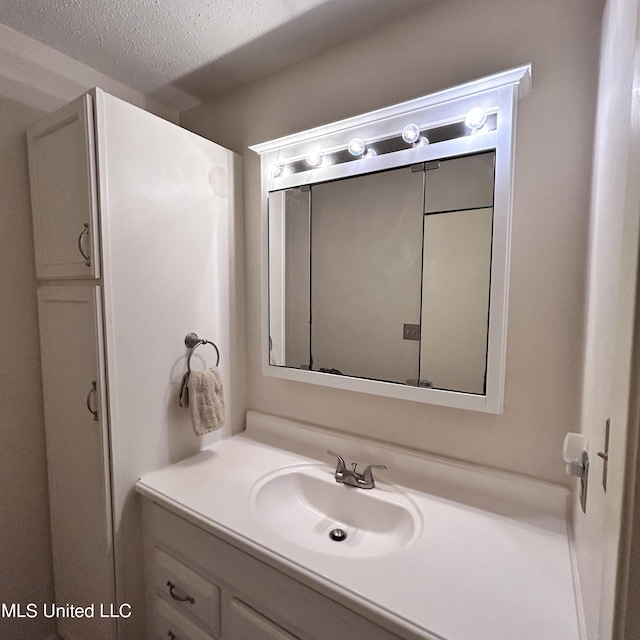 bathroom with vanity and a textured ceiling