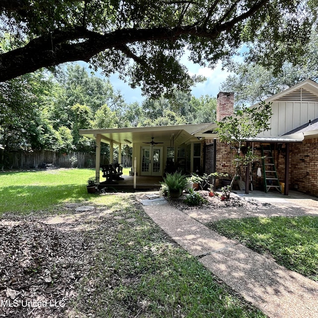 back of property featuring a patio, french doors, a lawn, and ceiling fan