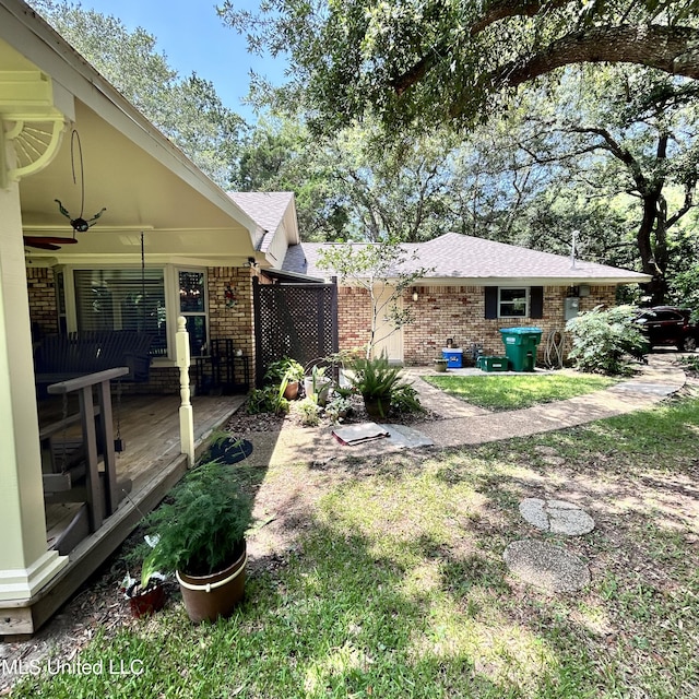 view of yard featuring a patio and ceiling fan