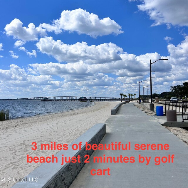 view of property's community with a water view and a view of the beach