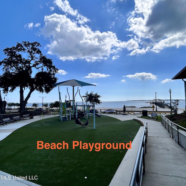 view of play area with a water view and a lawn