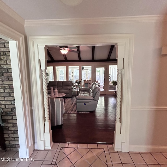 tiled living room with crown molding, french doors, and ceiling fan