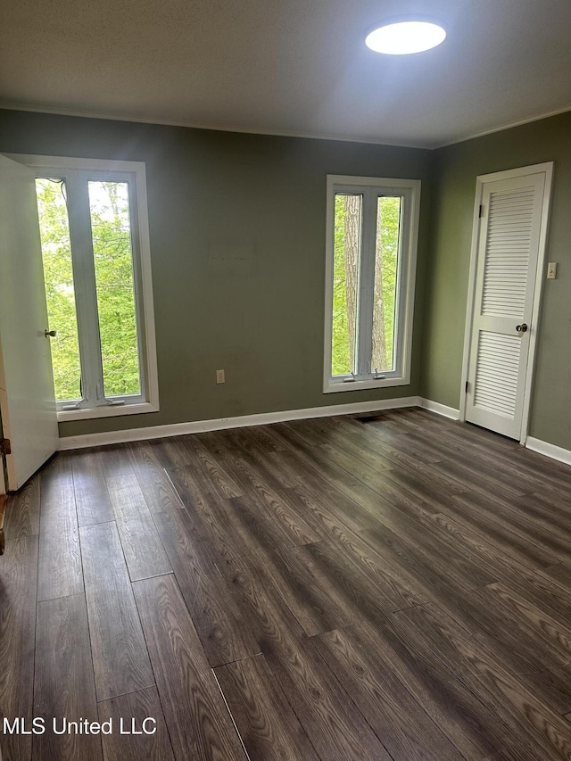 204 Fort Dr, Grenada, MS 38901 - spare room with baseboards and dark wood-style floors