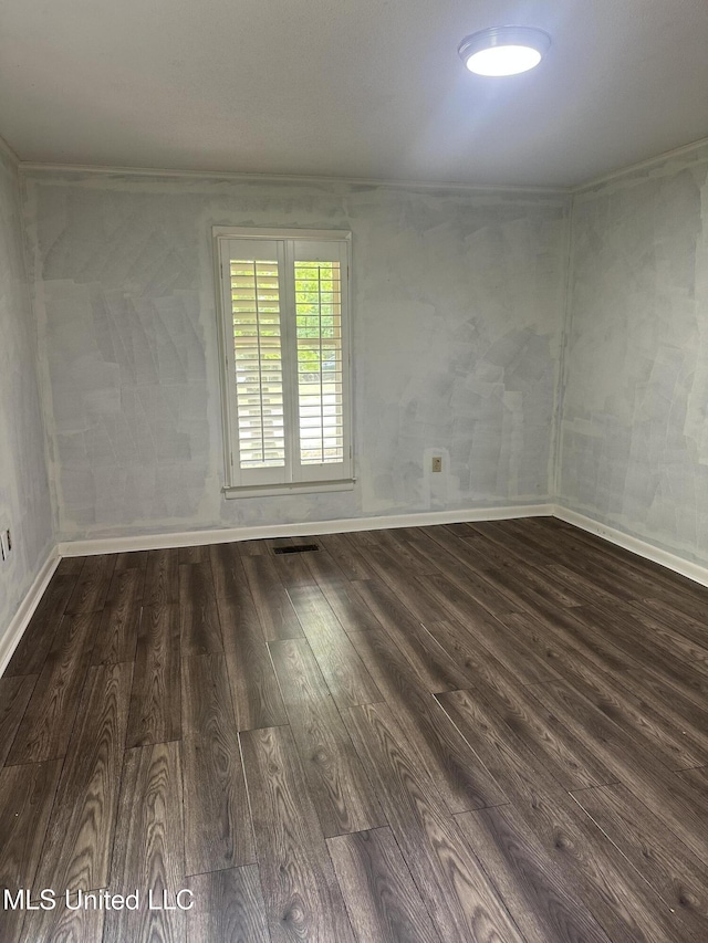 204 Fort Dr, Grenada, MS 38901 - empty room featuring baseboards, visible vents, dark wood-style floors, and ornamental molding