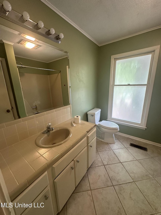 204 Fort Dr, Grenada, MS 38901 - full bathroom featuring tile patterned floors, vanity, toilet, ornamental molding, and visible vents