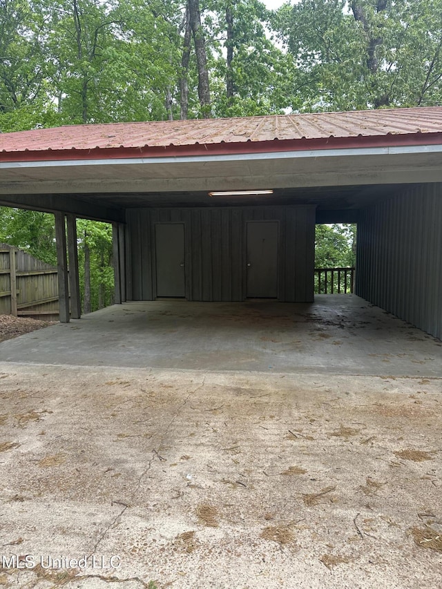 204 Fort Dr, Grenada, MS 38901 - garage featuring a carport, driveway, and fence