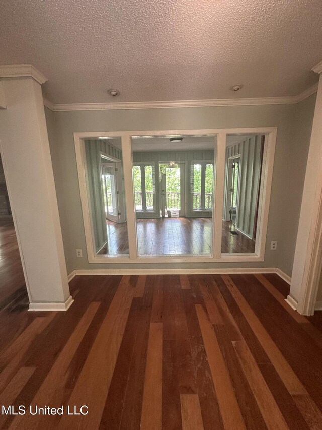204 Fort Dr, Grenada, MS 38901 - spare room with baseboards, a textured ceiling, and dark wood-type flooring