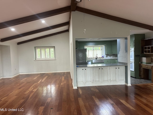 204 Fort Dr, Grenada, MS 38901 - kitchen with a sink, lofted ceiling with beams, white double oven, dark wood finished floors, and freestanding refrigerator