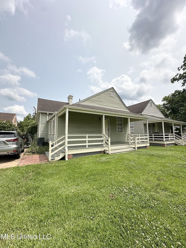 310 N Rankin St, Natchez, MS 39120 - farmhouse featuring a porch, a front lawn, a shingled roof, and a chimney