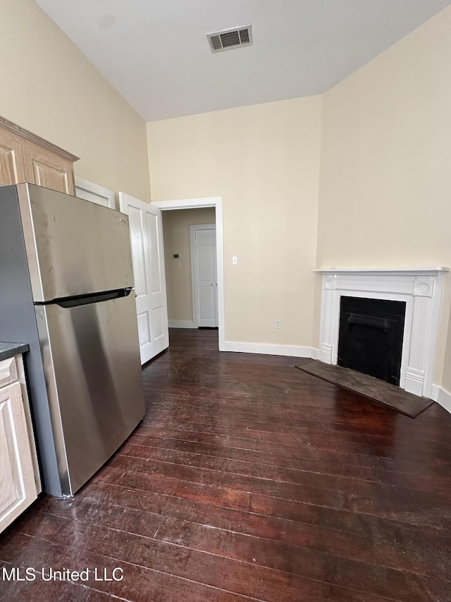 310 N Rankin St, Natchez, MS 39120 - unfurnished living room with hardwood / wood-style floors, a fireplace with flush hearth, and baseboards