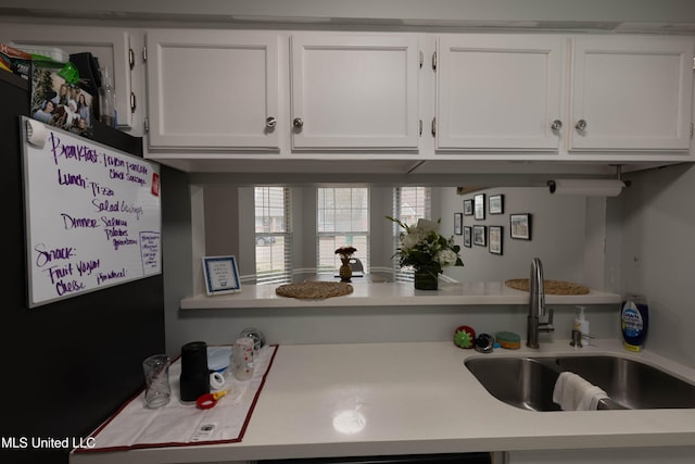 kitchen with white cabinetry and sink