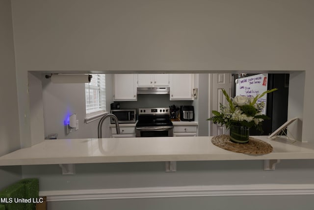 kitchen with white cabinetry, appliances with stainless steel finishes, and sink