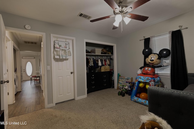 recreation room with ceiling fan and carpet