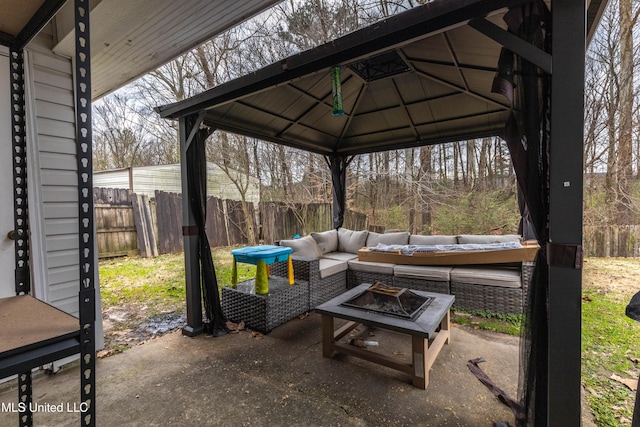 view of patio with a gazebo and an outdoor living space with a fire pit