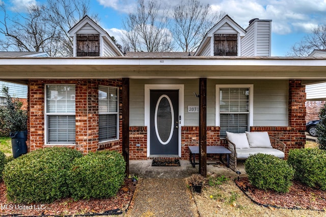 view of exterior entry featuring a porch