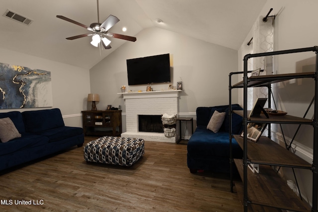 living room featuring a brick fireplace, dark wood-type flooring, high vaulted ceiling, and ceiling fan