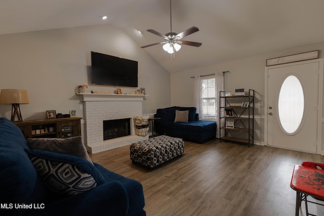 living room featuring wood-type flooring, high vaulted ceiling, ceiling fan, and a fireplace