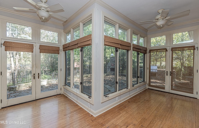 unfurnished sunroom with french doors, a wealth of natural light, and ceiling fan