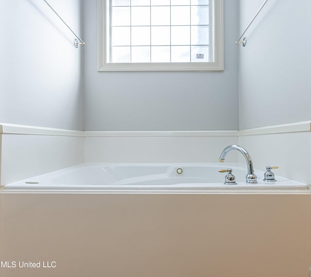 bathroom with a tub to relax in